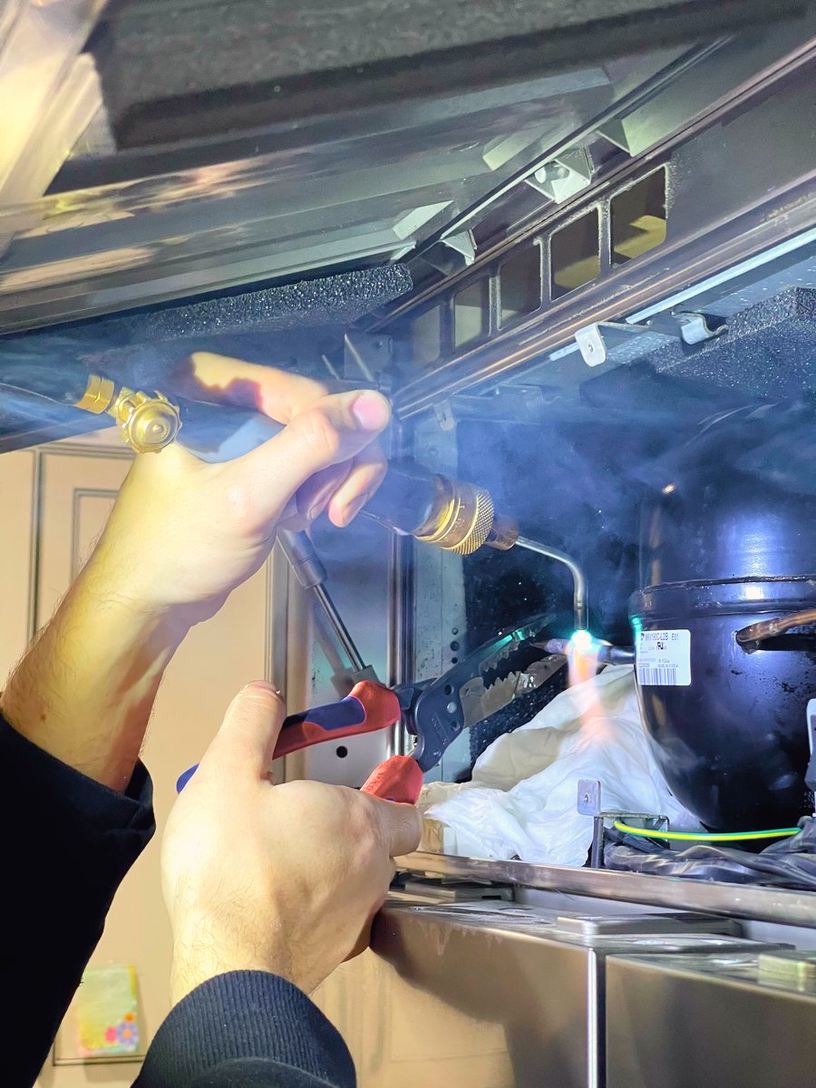 Appliance Rescue Team technician replacing a refrigerator compressor in Bergen County, NJ