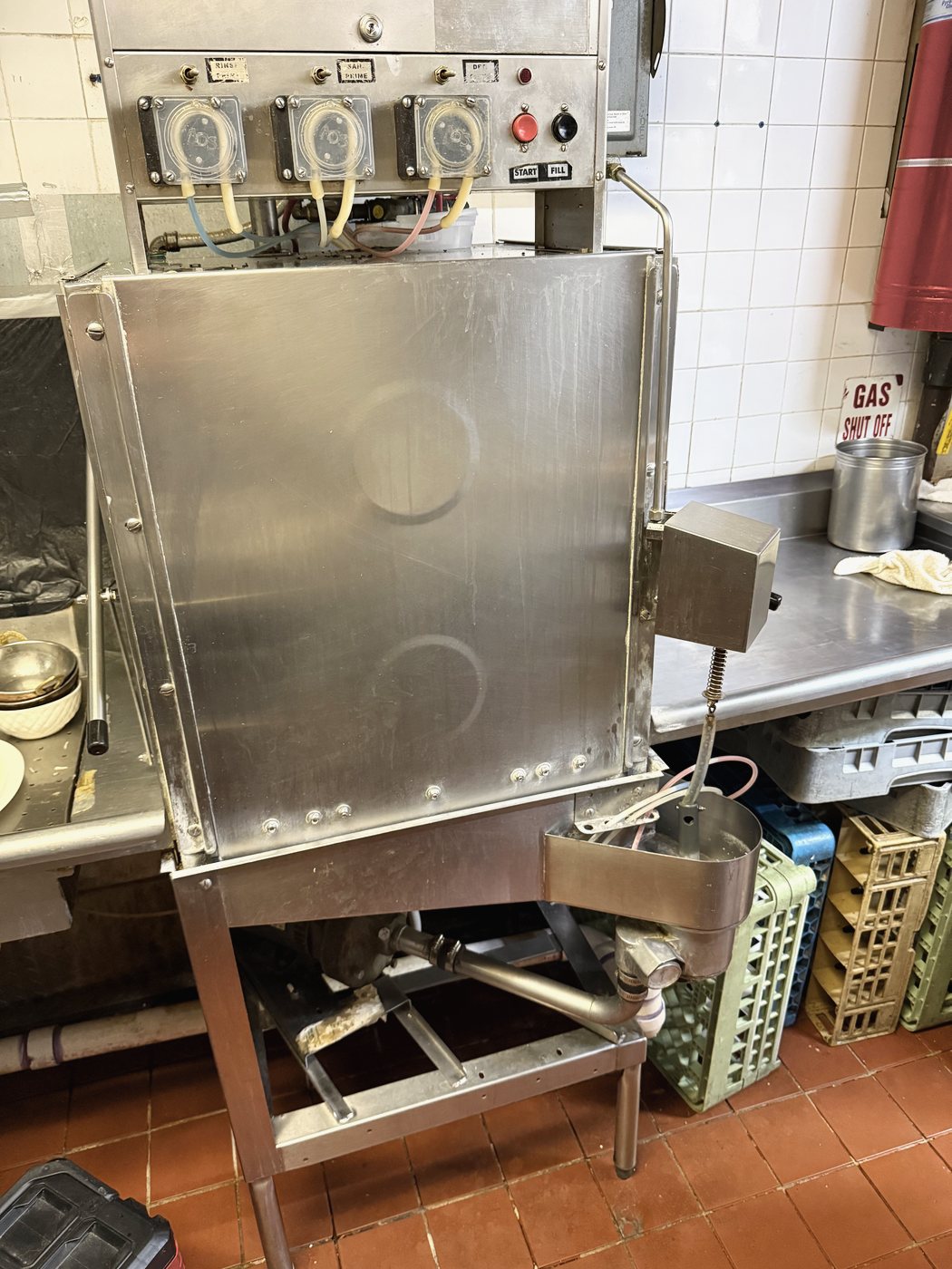 The American Dish Service machine this repair was done on — a door-type dish machine in a working kitchen