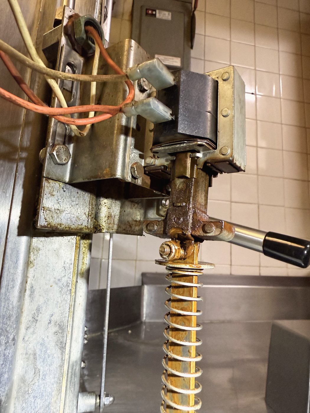 The valve assembly with its lever. Replaced complete rather than adjusted — at this age the adjustment does not hold