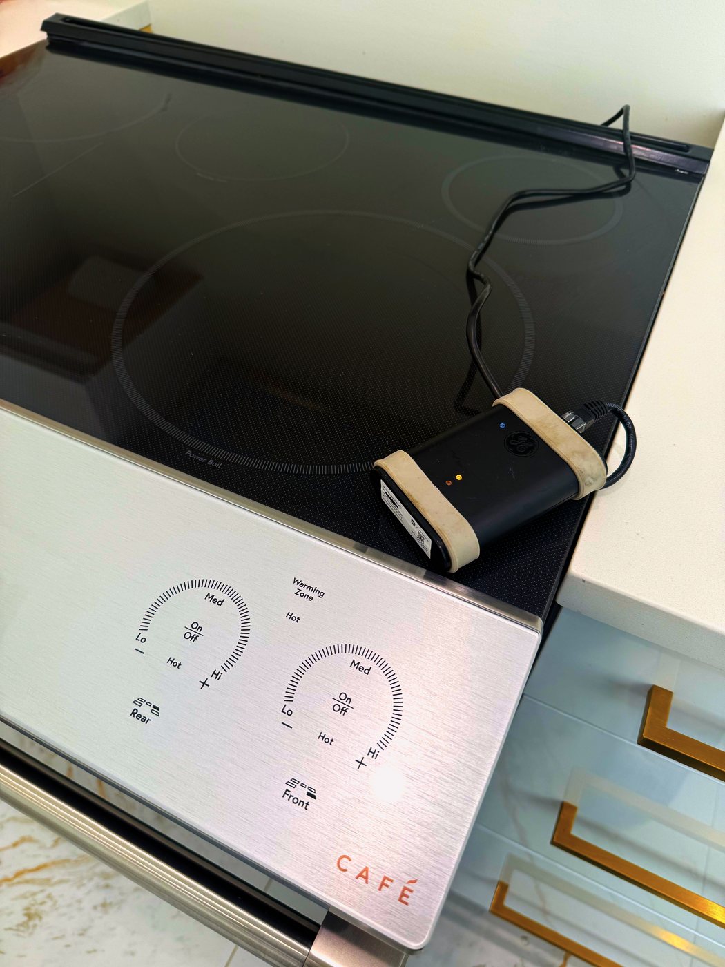 The GE service diagnostic tool on the glass. It reads what the range's own boards report, instead of leaving us to guess from the outside